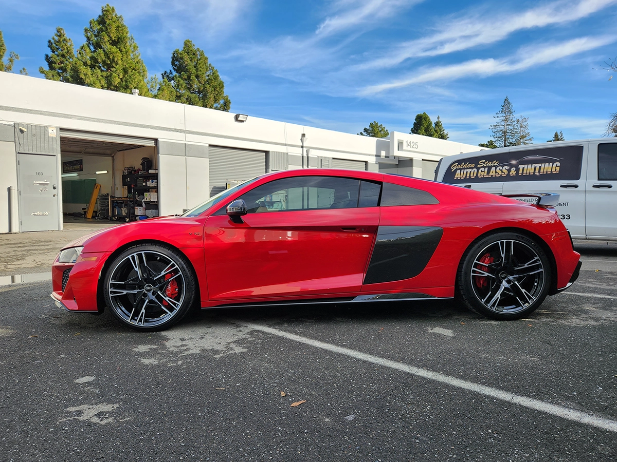 Glossy vehicle finish protected with paint protection film and ceramic coating